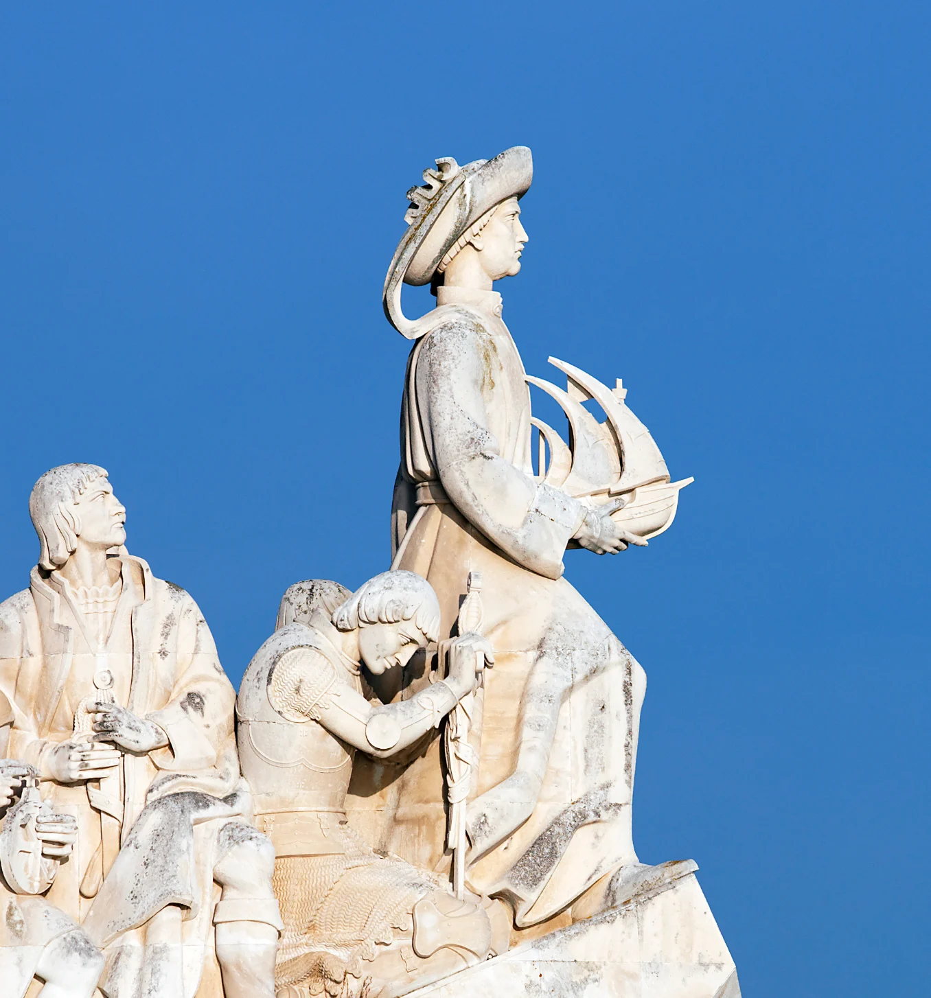 Monument to the Discoveries in Lisbon with the 25 de Abril Bridge behind